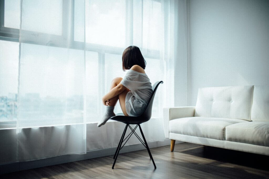 sad woman sitting on black chair- Mental Health